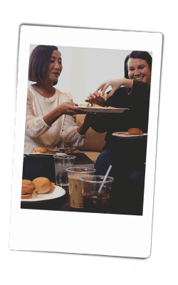 Instax picture of women passing food