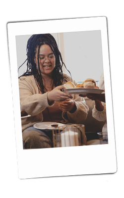 Instax picture of a woman grabbing a plate of food