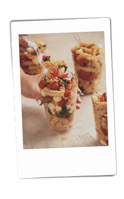 Instax picture of caprese pasta salad served in Chinet Crystal cups