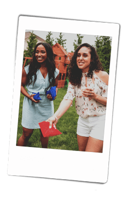 Instax picture two women playing corn hole bags