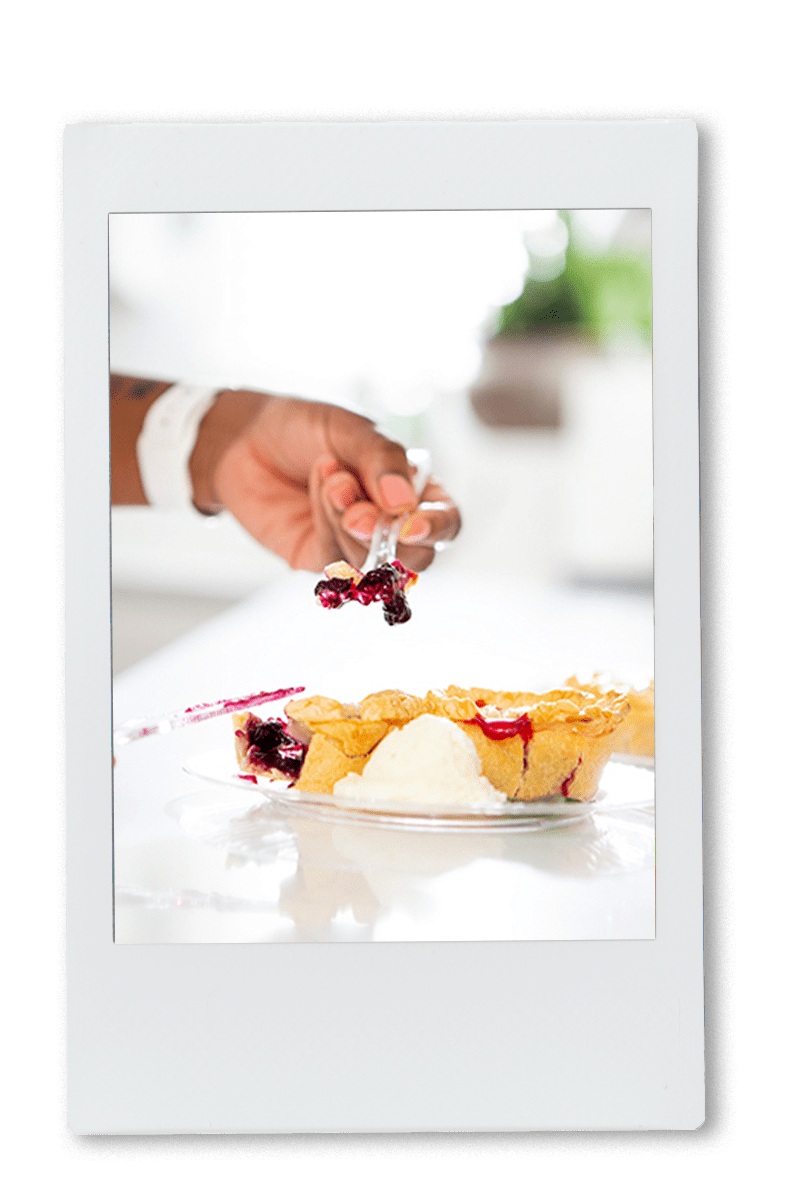 Instax picture of a hand picking up a slice of pie