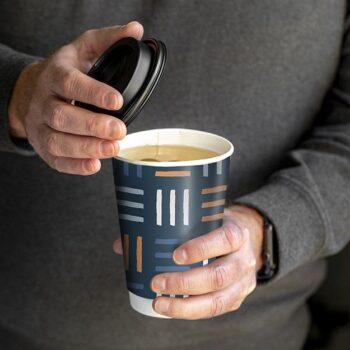 Person holding remedy tea in a chinet comfort cup