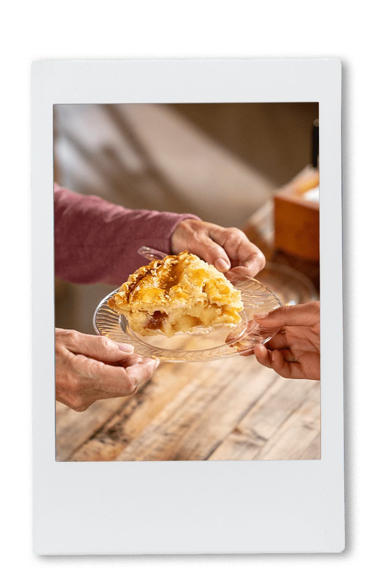 Instax of grandma passing apple pis on a Chinet crystal plate