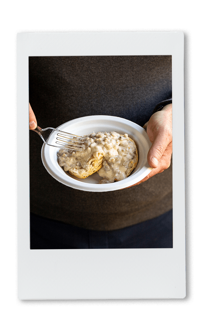 Instax of man eating biscuits and gravy