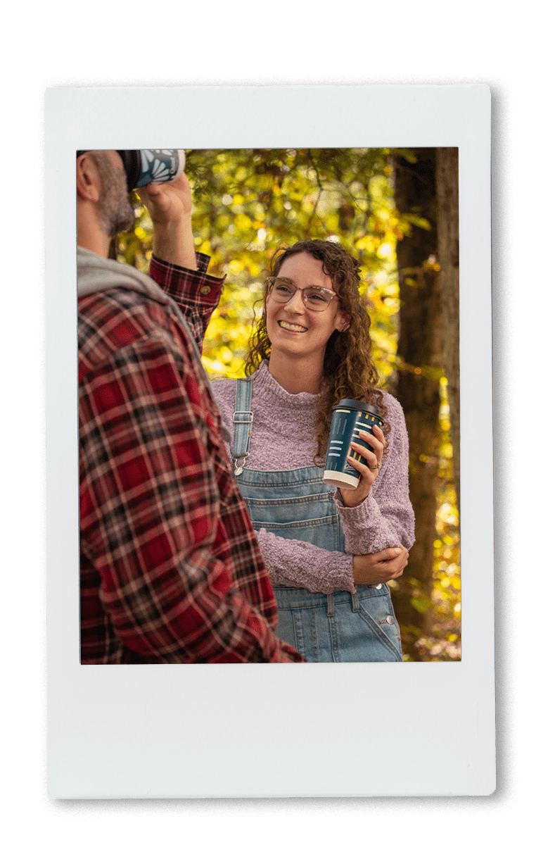 Instax of girl laughing and drinking out of a chinet comfort cup