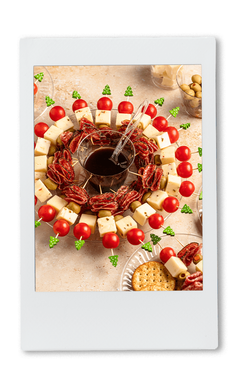 Instax of Wreath of Charcuterie on a Chinet plate with balsamic dressing