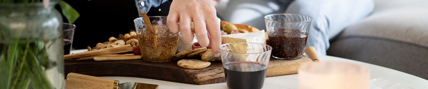 Hand reaching for a charcuterie board