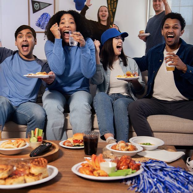 Group of friends cheering on a couch