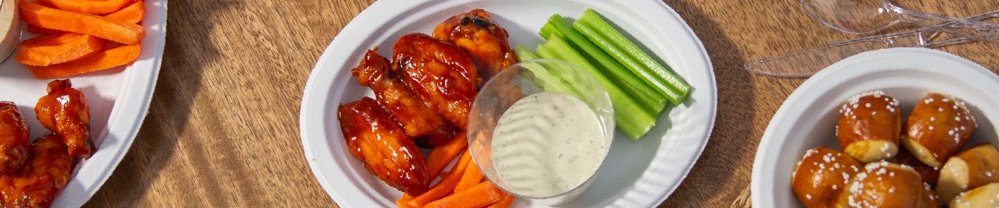 Buffalo chicken wings, celery sticks and ranch dressing served on a Chinet Classic sampler platter