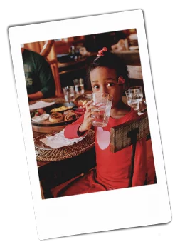 Instax picture of a young girl drinking from a Chinet Crystal cup