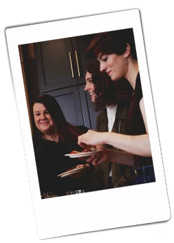 Instax picture of a group of women holding a Chinet Classic plates of appetizers