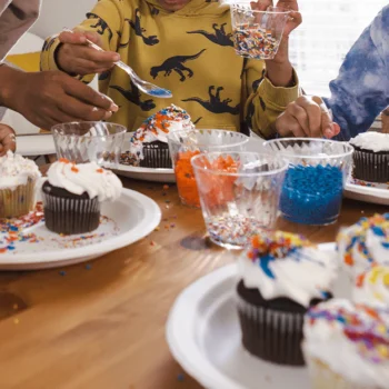 Brother and sister decorating cupcakes