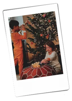 Instsax picture of a brother and sister decorating a Christmas tree