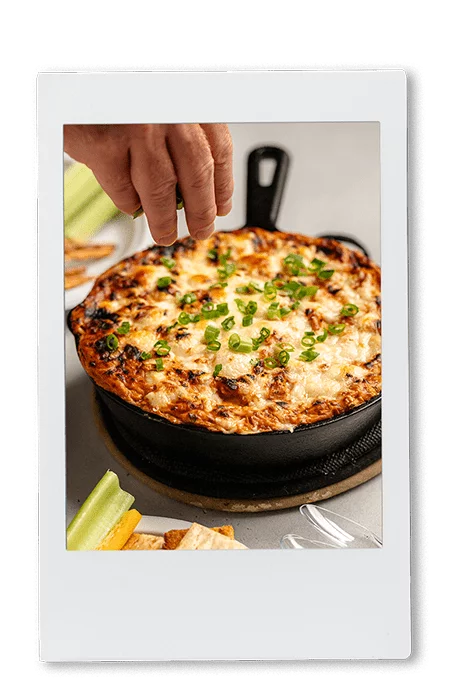 Instax picture of a BBQ chicken pizza dip in a cast iron pan