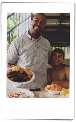 Instax picture of a father and son serving hamburgers