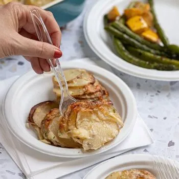 Cheesy Hassleback potatoes served on a Chinet Classic plate