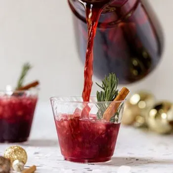 Pouring red sangria into a Chinet Crystal cup