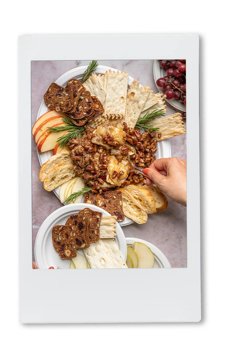 Instax picture of a hand dipping cutting 