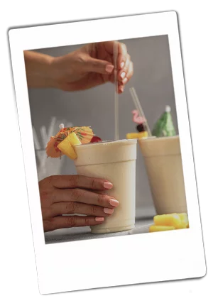 Instax picture of hands stirring a pina colada served in a Chinet Classic Recycled Clear Cup