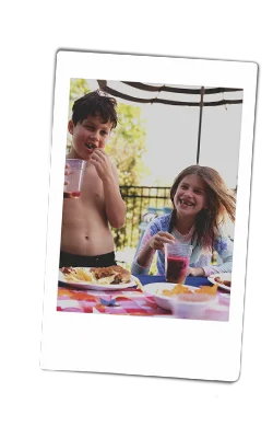 Instax of kids laughing at a pool party with chinet products