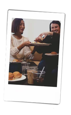 Instax picture of women passing food