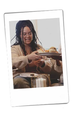 Instax picture of a woman grabbing a plate of food