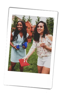 Instax picture two women playing corn hole bags