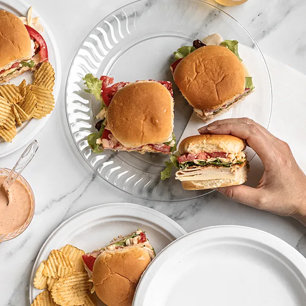 Bacon tomato turkey sliders served on a Chinet brand plates with potato chips