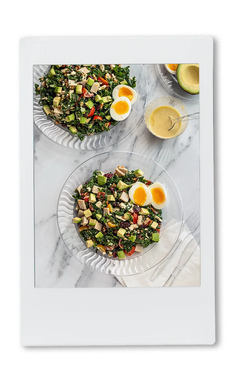 Instax of Chopped turkey cobb salad on a chinet crystal plate