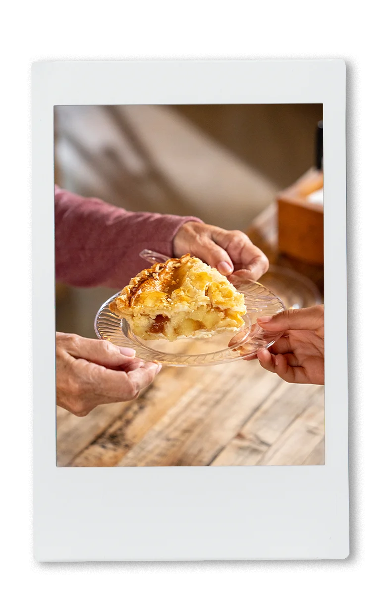 Instax of grandma passing apple pis on a Chinet crystal plate