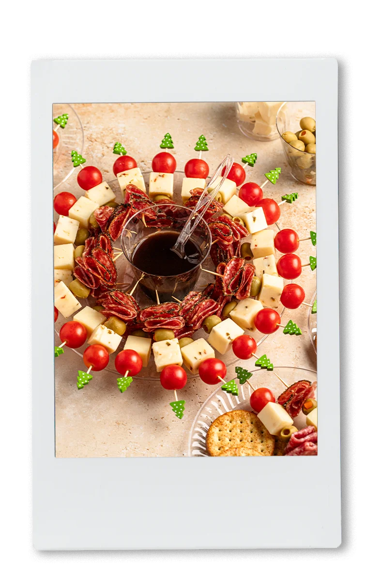 Instax of Wreath of Charcuterie on a Chinet plate with balsamic dressing